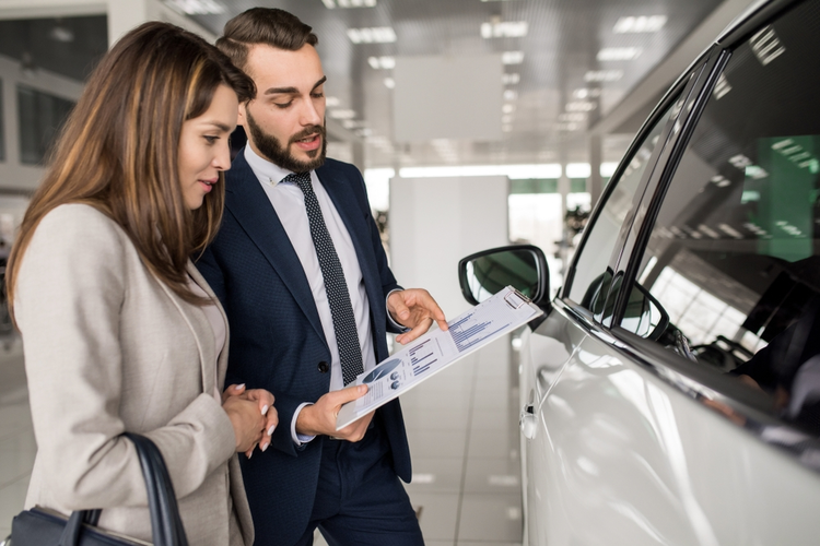 Car salesman talking to customer.